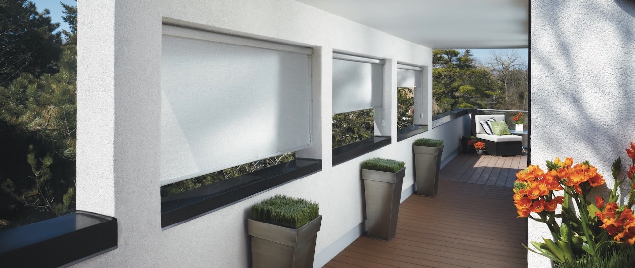 Roof top deck with modern planters and white roller shades